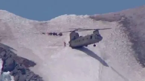 นักบินชีนุคโชว์ทักษะสุดยอด! ช่วยผู้ประสบภัยลงจากยอดเขา (คลิป)