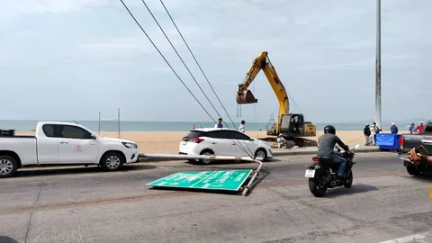 แขนแบ็กโฮเกี่ยวสายไฟ ดึงป้ายบอกทางริมถนนเลียบหาดจอมเทียนล้มทับคน สาหัส 1 