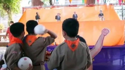 สรุปดราม่า "โรงเรียนดัง" จัดกิจกรรมเล่นเกม "ปากระป๋อง" ใส่ภาพนักการเมือง