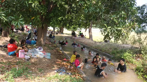 คนเมืองสองแคว แห่เที่ยวคลองส่งน้ำ ต.หัวรอ แห่เล่นน้ำดับความร้อน 40 องศาฯ