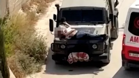 อิสราเอลรับ มัดชายปาเลสไตน์ที่บาดเจ็บไว้บนกระโปรงรถ ขณะบุกเจนิน