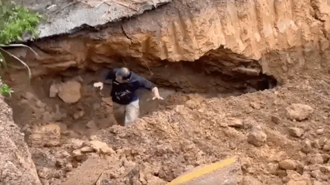 นาทีชีวิต ถนนถล่มทับเจ้าหน้าที่เทศบาลฯ ระหว่างขุดท่อระบายน้ำ (คลิป)