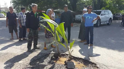 ชาวบ้านไม่ทน! ปลูกต้นกล้วย ต้นมะพร้าวกลางถนนชำรุด ร้องจนท.เร่งซ่อม 