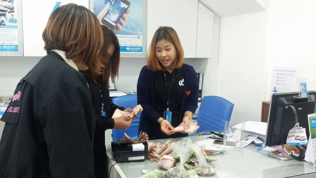 เจ้าหน้าที่ธนาคารกรุงไทยกำลังตรวจนับเงินให้กับนายฮกจ๋าย จำนวน 138,928 บาท