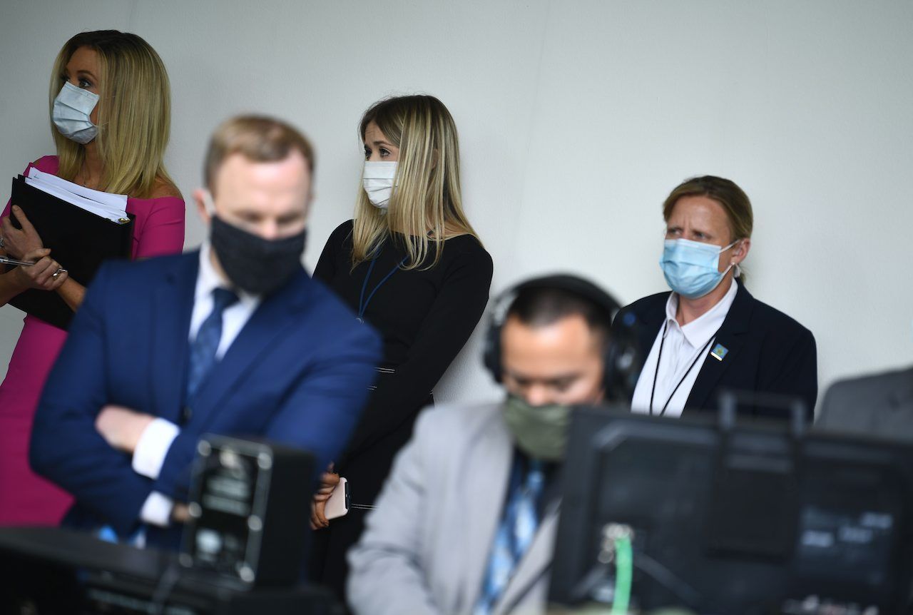 เจ้าหน้าที่ทำเนียบขาวทุกคน รวมทั้งนาง เคลีห์ แมคเอนานี (เสื้อชมพู) เลขาธิการฝ่ายสื่อประจำทำเนียบขาว สวมหน้ากากฟังการแถลงข่าวของนายทรัมป์