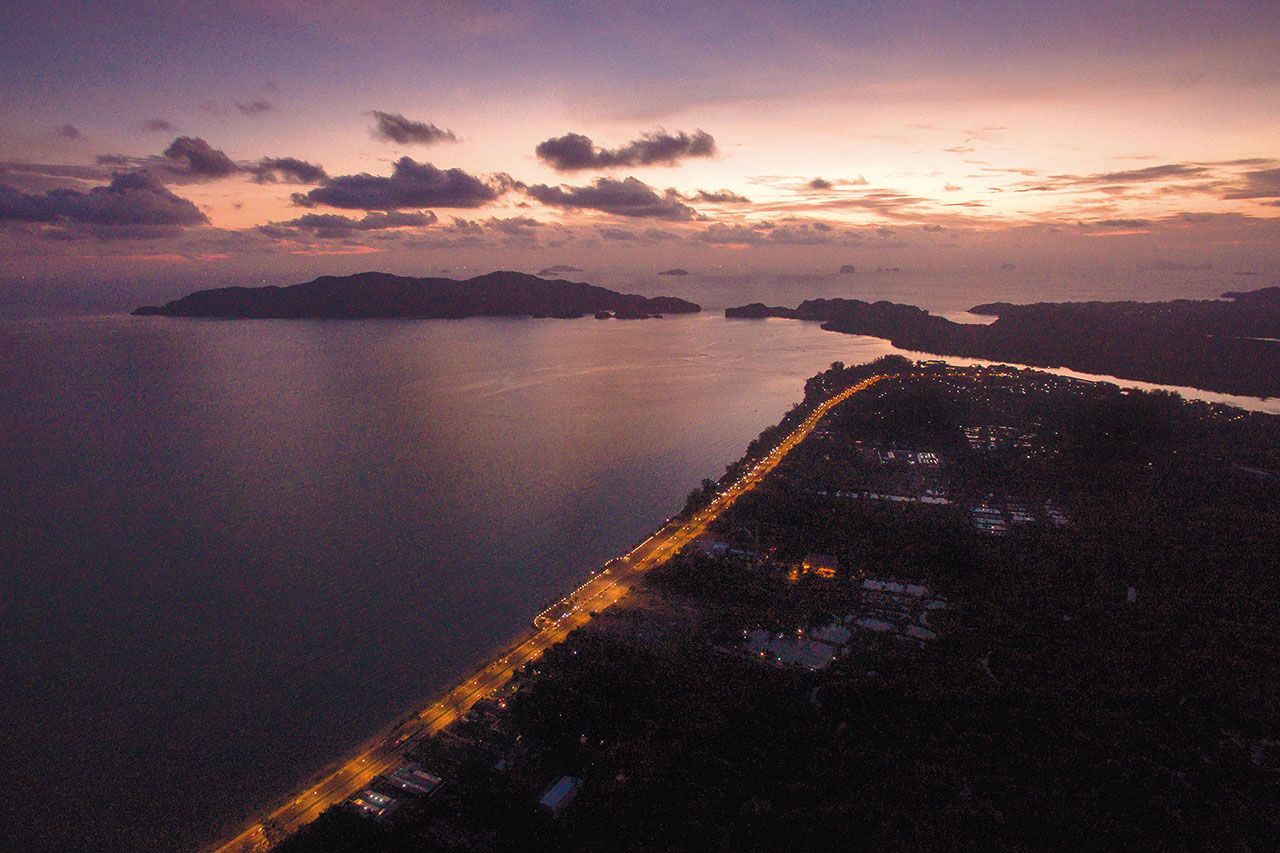 ภาพมุมสูงยามเย็นของชายหาดและหมู่เกาะบริเวณอ่าวปากบาราซึ่งจะใช้เป็นพื้นที่ก่อสร้างท่าเรือน้ำลึกตาม โครงการก่อสร้างท่าเรือน้ำลึกปากบารา คนทั่วไปรู้จักปากบาราในฐานะที่เป็นประตูสู่แหล่งท่องเที่ยว เช่น เกาะหลีเป๊ะ เกาะตะรุเตา นอกเหนือจากการหล่อเลี้ยงอุตสาหกรรมประมงด้วยระบบนิเวศทางทะเลที่อุดมสมบูรณ์