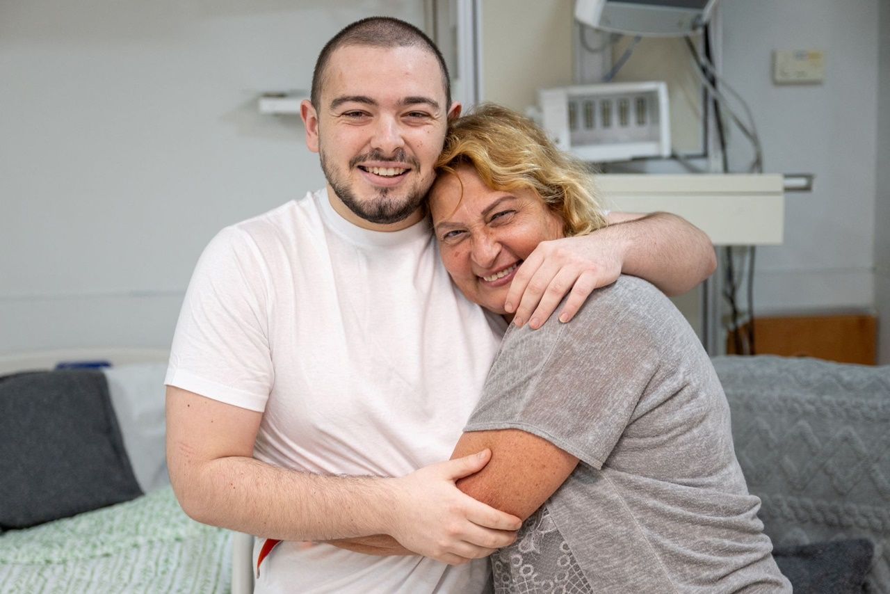 Almouk Mir Jan hugs his mother after her release