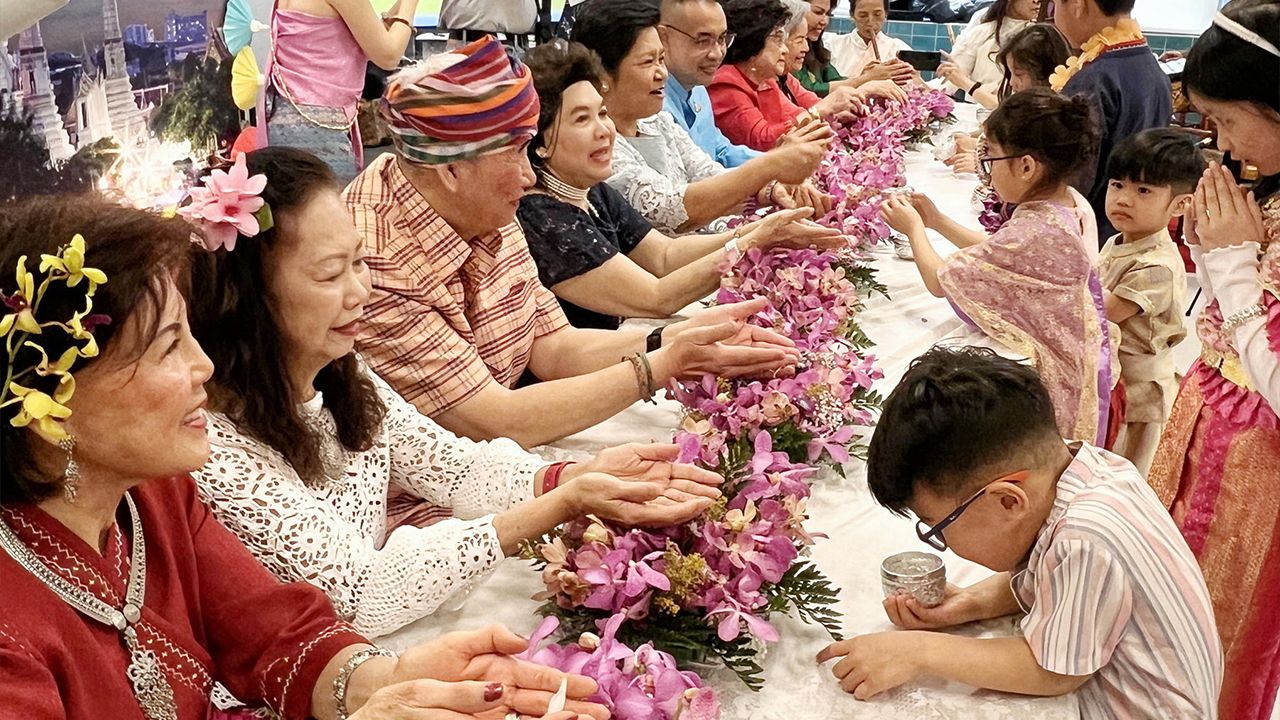 Songkran Day - Somjay Tafau Bong, M.D., New York City, USA, and Suchitra Paliung, President of the New York State Cultural Center presided over the ceremony of bathing the Buddha image and pouring water to seek blessings at an event 