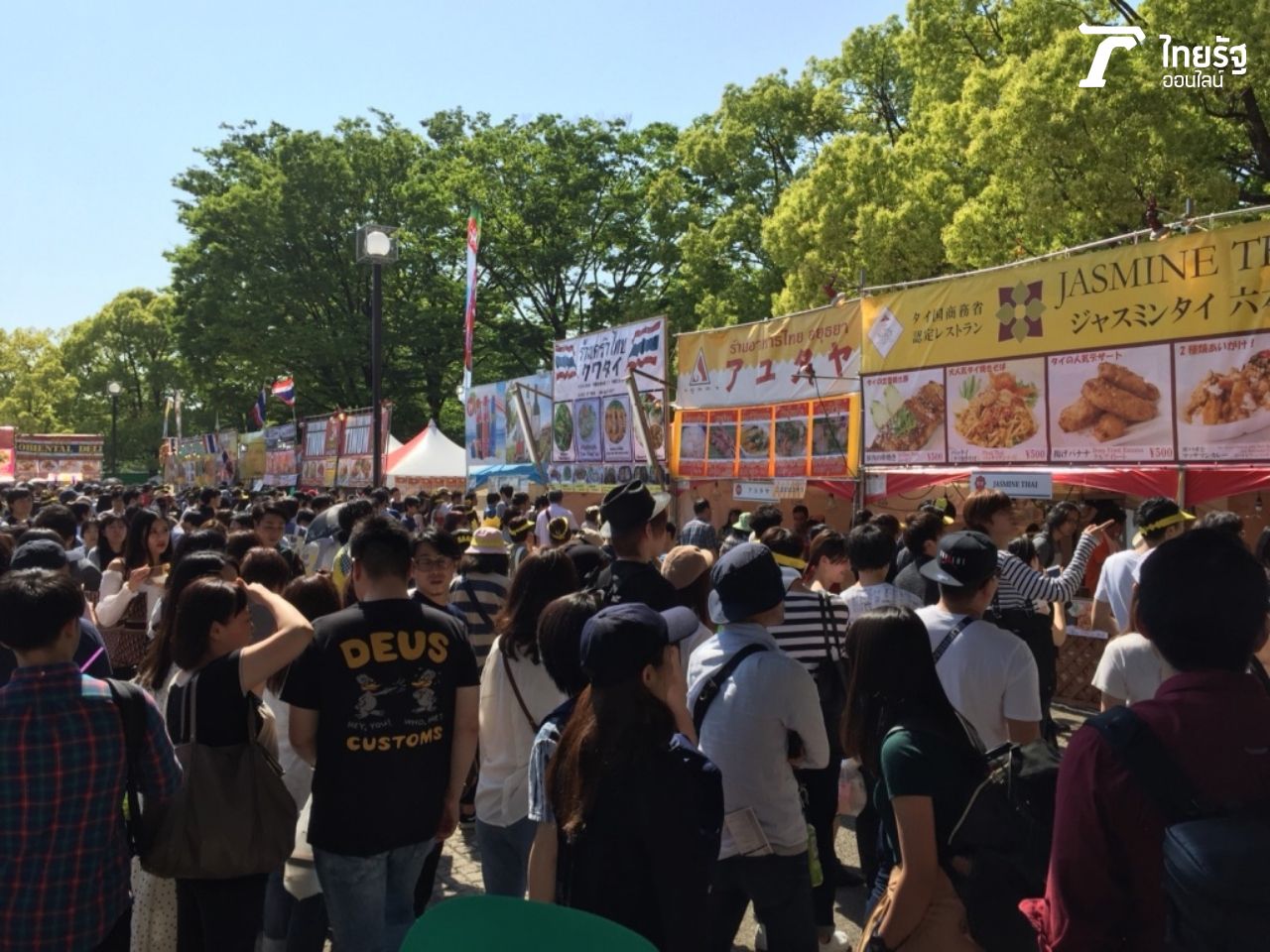 พื้นที่ด้านหน้าบูธอาหาร เต็มไปด้วยผู้คนที่ต่อคิวซื้ออาหาร